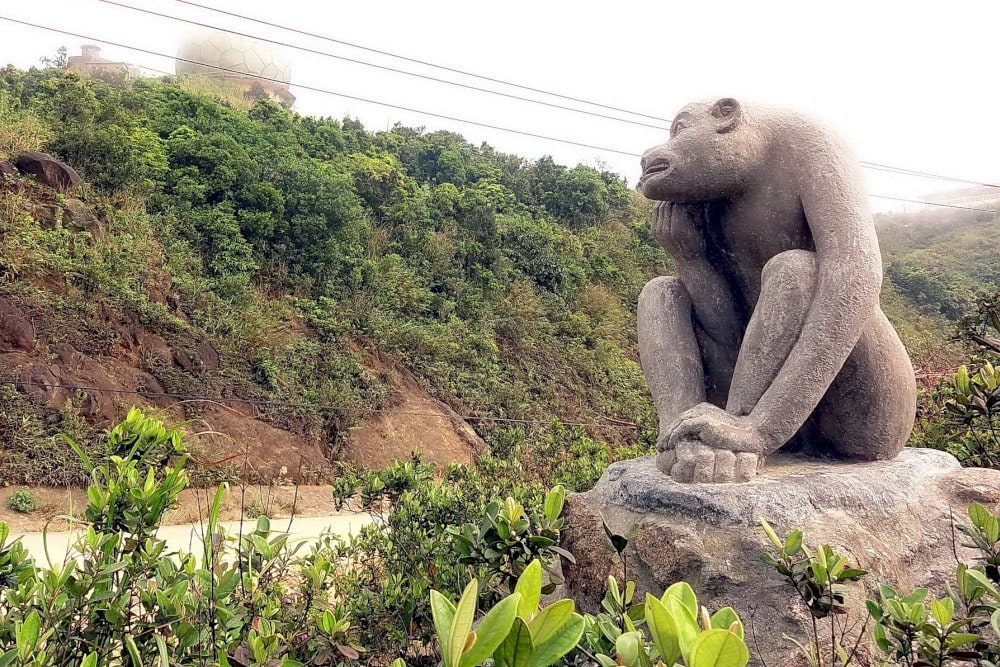 Monkey statues in different colors line the path up Monkey Mountain,